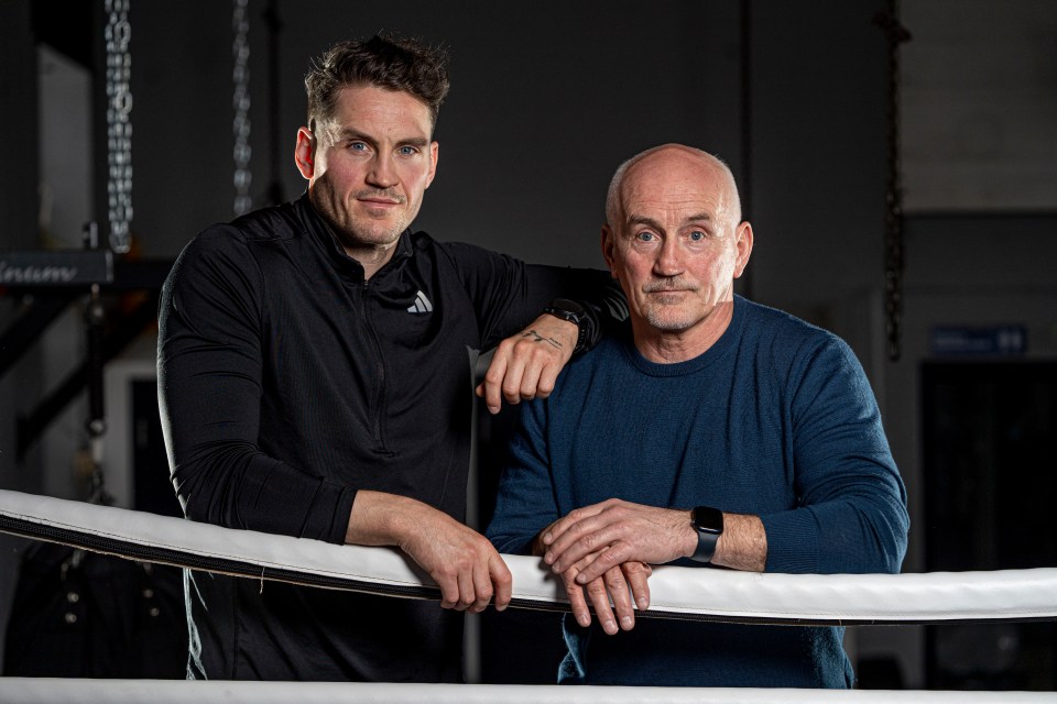 two men standing next to each other with one wearing an adidas shirt