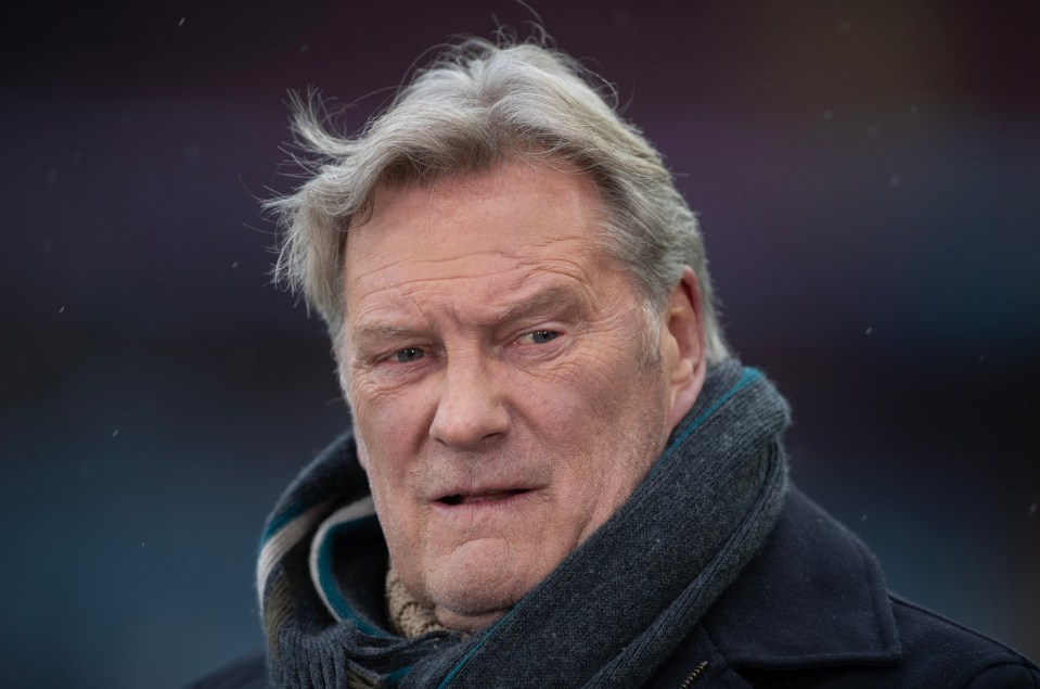 a man with gray hair and a scarf around his neck