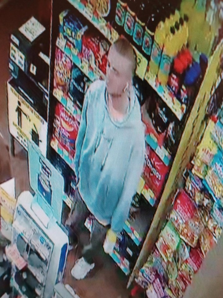 a man in a blue hoodie stands in front of a display of chips