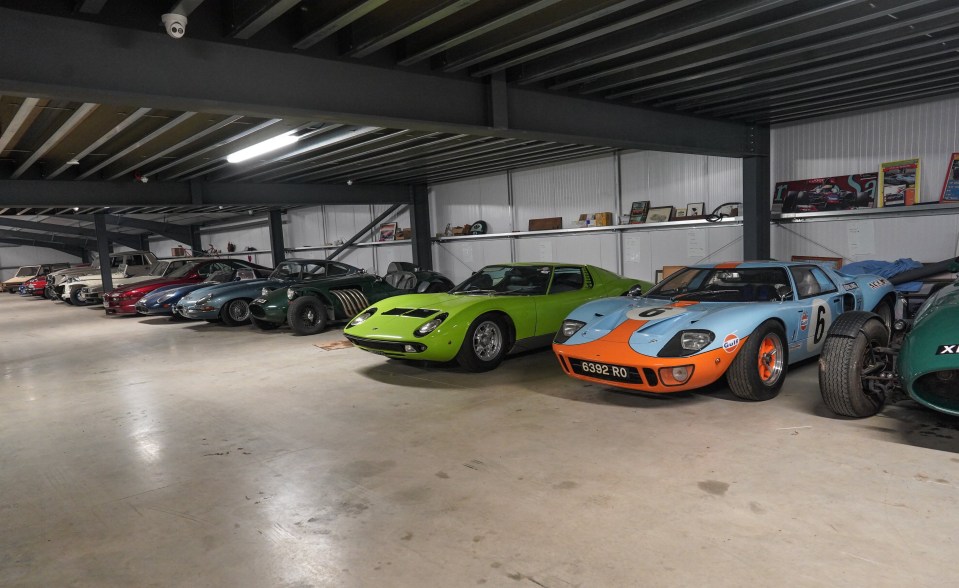 A collection of classic cars in a garage.