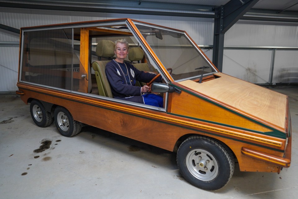 Woman sitting in a wooden car.