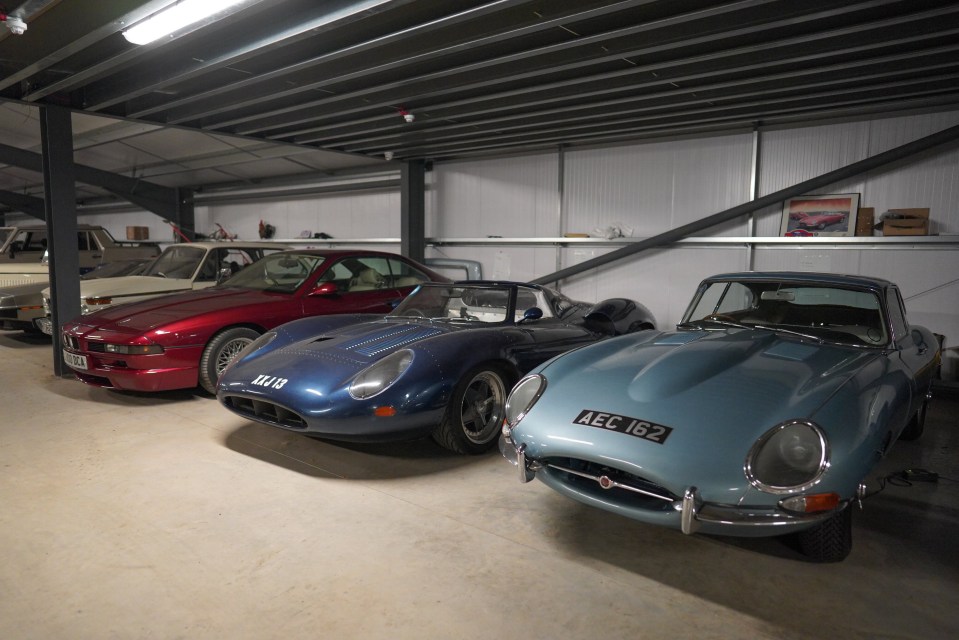 A collection of classic cars in a garage.