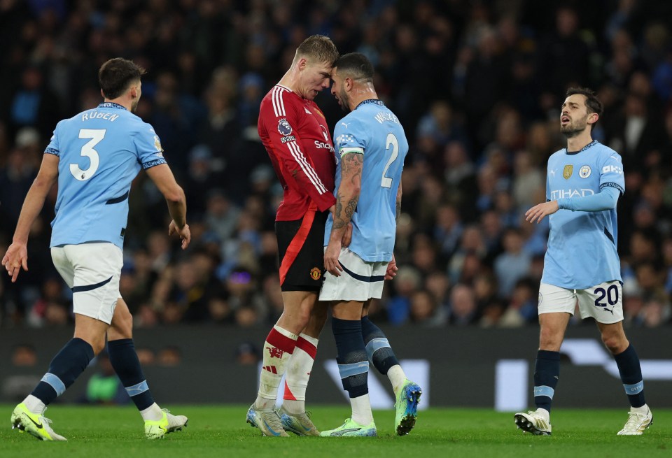 Manchester United's Rasmus Hojlund and Manchester City's Kyle Walker in a confrontation during a soccer match.