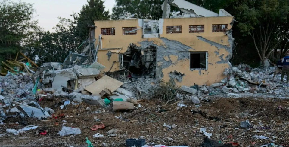 Body bag in the rubble of a destroyed building.
