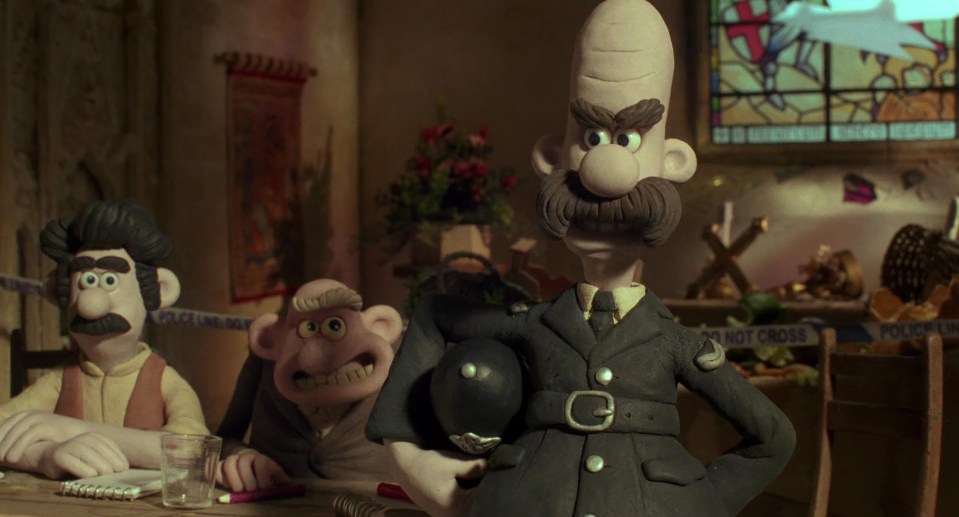 A scene from Wallace & Gromit: The Curse of the Were-Rabbit, featuring a police officer and two other characters.