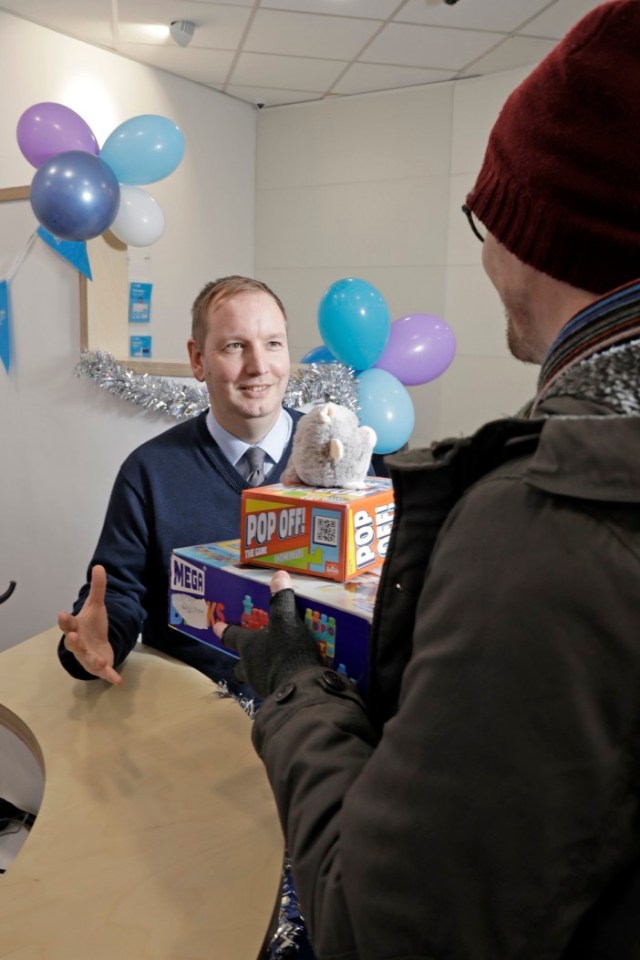 *** FREE FOR EDITORIAL USE ***.A member of the public donates toys to the Leeds branch of Skipton Building Society.