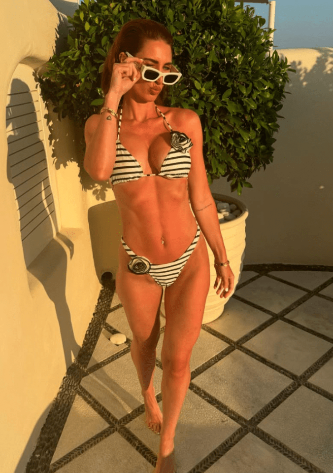 Woman in striped bikini and sunglasses.