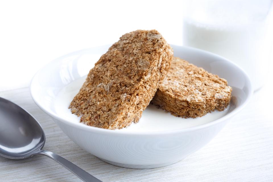 Whole wheat biscuits in a bowl of milk.