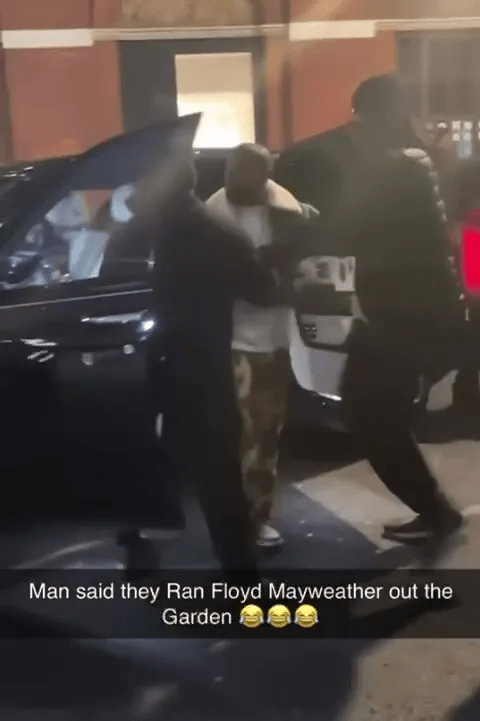 Floyd Mayweather being escorted to a car.