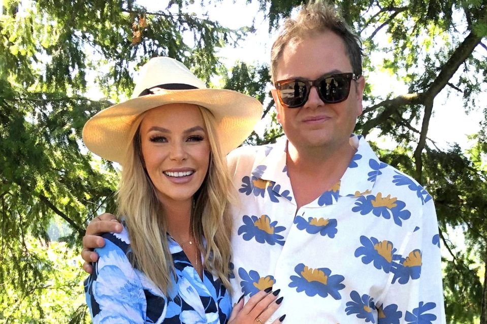 A woman and a man posing together outdoors.