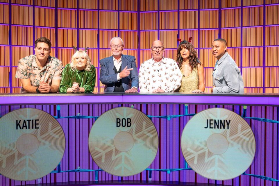 OJ Borg, Katie Thistleton, Bob Harris, Ken Bruce, Jenny Powell, and Rickie Haywood-Williams on a game show.
