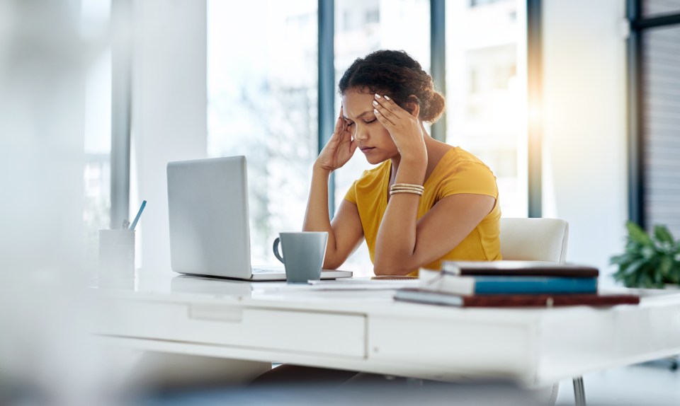 Stressed young designer at her desk.