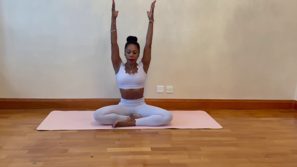 Woman performing yoga stretch to relieve trapped wind.