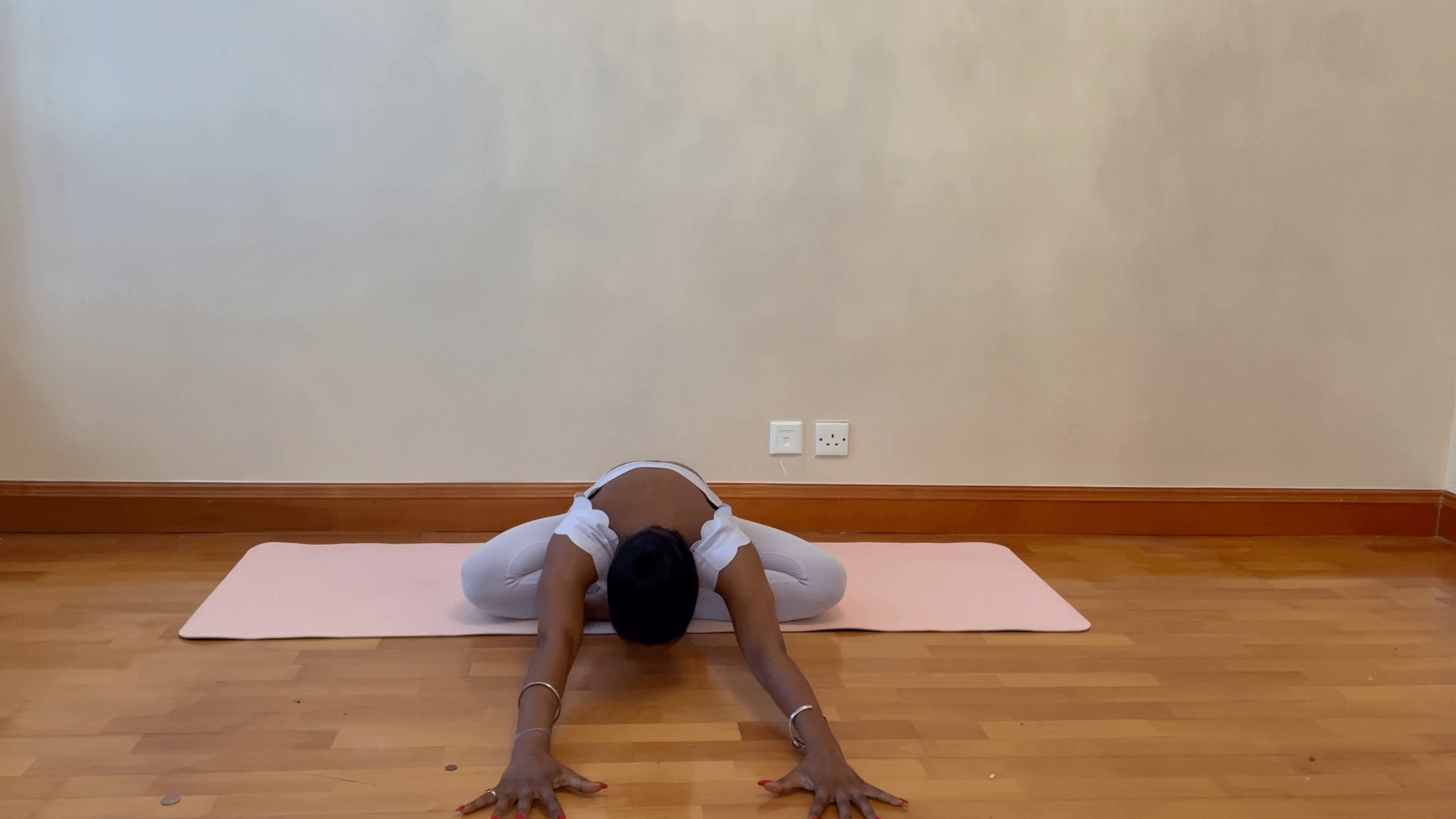 Person performing a yoga stretch to relieve trapped wind.