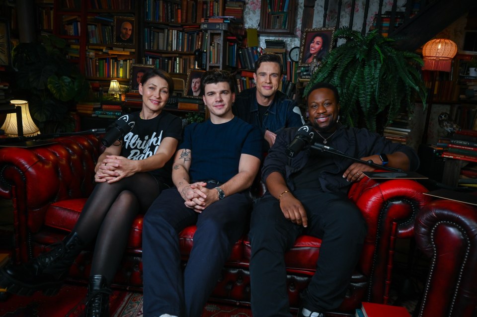Four people sit on a red couch for a podcast recording.