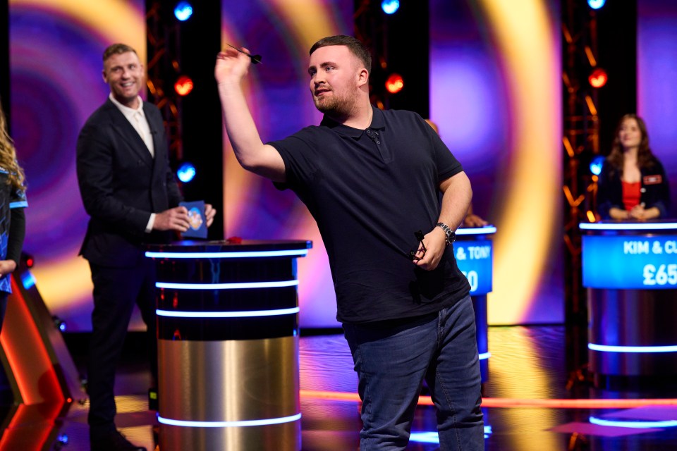 Luke Littler throwing a dart on the game show Bullseye.