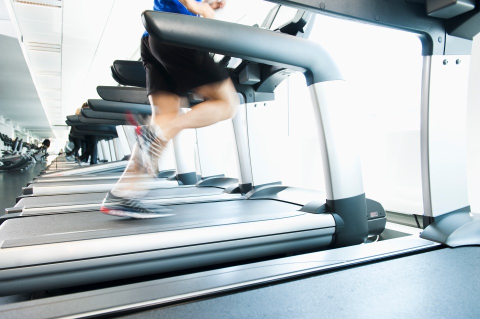 Man running on a treadmill at the gym.