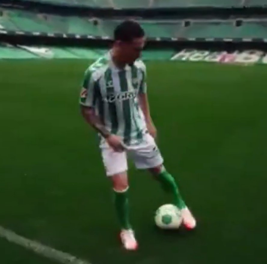Soccer player juggling ball in stadium.