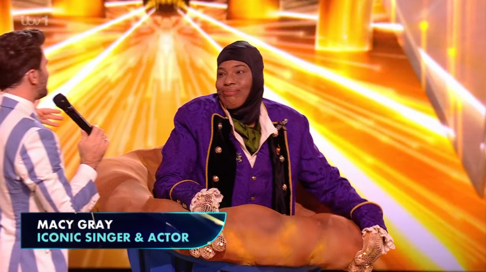 Macy Gray, iconic singer and actor, in a purple jacket.