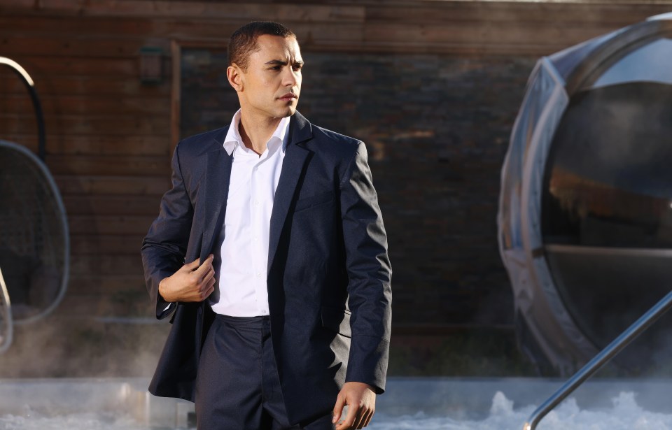 Man in suit near a pool.