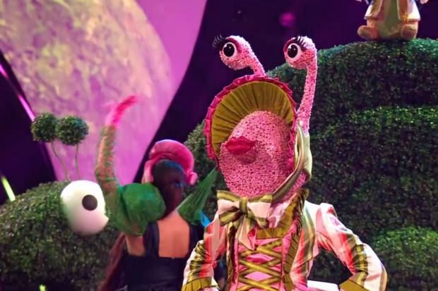 Pink snail costume on stage.