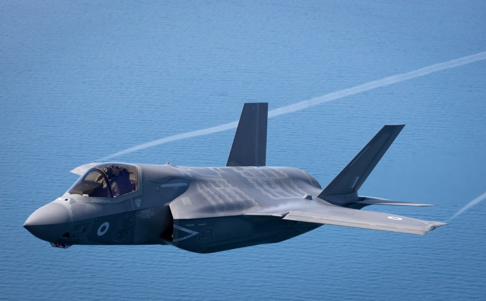 F-35B Lightning II jet flying over the sea.