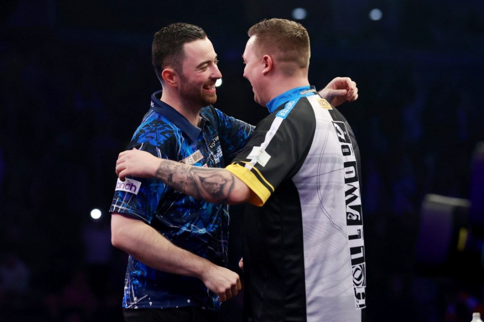 Luke Humphries (left) reacts after winning his match against Chris Dobey (right) on night one of the 2025 BetMGM Premier League at the SSE Arena, Belfast. Picture date: Thursday February 6, 2025. PA Photo. See PA story DARTS Belfast. Photo credit should read: Liam McBurney/PA Wire. RESTRICTIONS: Use subject to restrictions. Editorial use only, no commercial use without prior consent from rights holder.