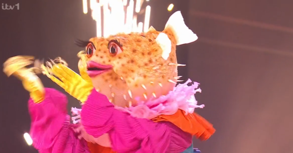 Pufferfish costume performing on stage.