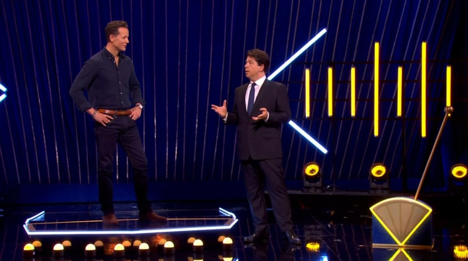 Screenshot of two men on a game show set.