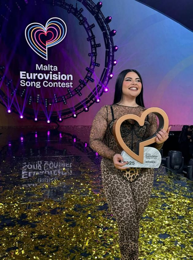 Winner of the Malta Eurovision Song Contest holding an award.