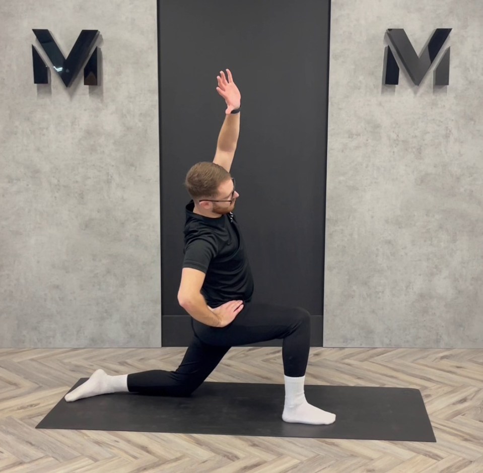 Man stretching on yoga mat.