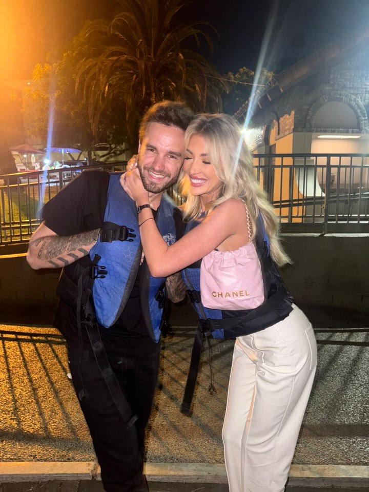 Kate Cassidy and Liam Payne embracing, wearing life vests.