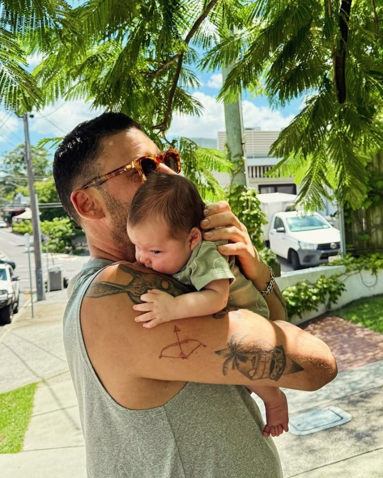 A father holding his baby son.