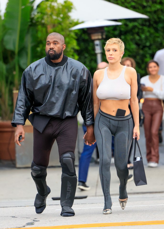 Kanye West and Bianca Censori walking hand-in-hand.