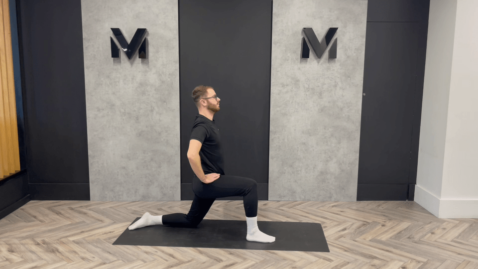 Man stretching on yoga mat.