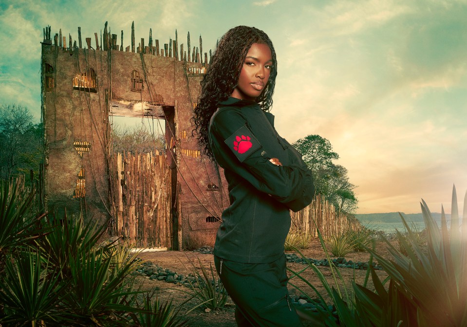 Leomie Anderson, contestant on Celebrity Bear Hunt, standing before a rustic gate.