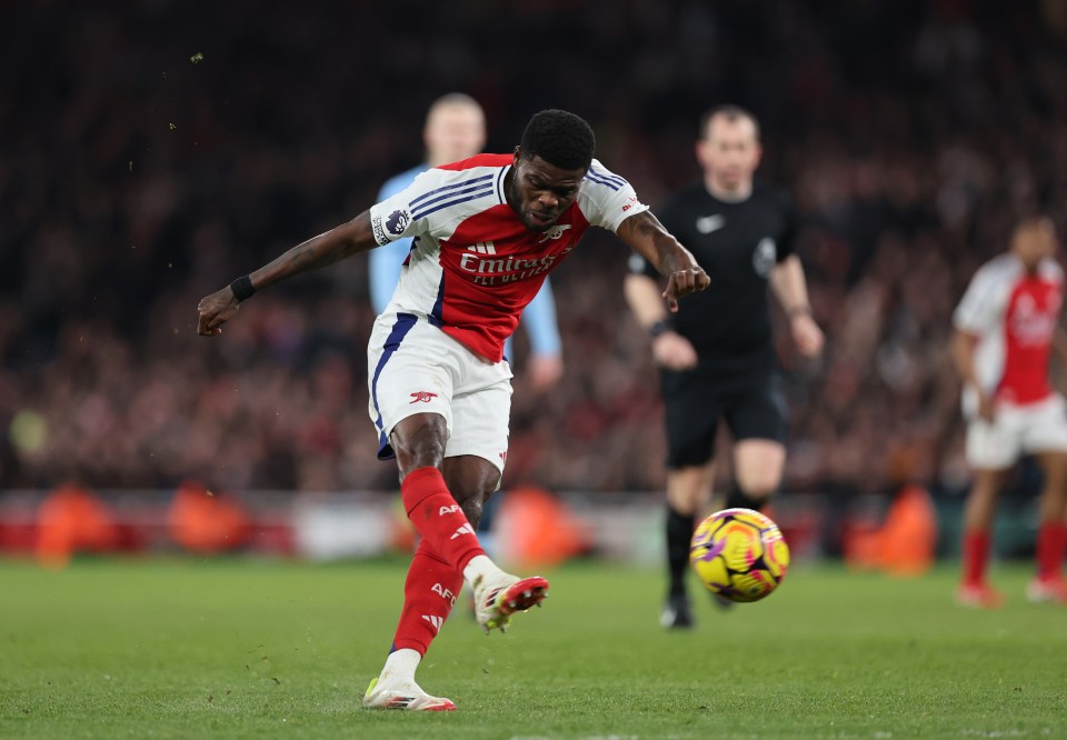 Thomas Partey of Arsenal kicking a soccer ball.