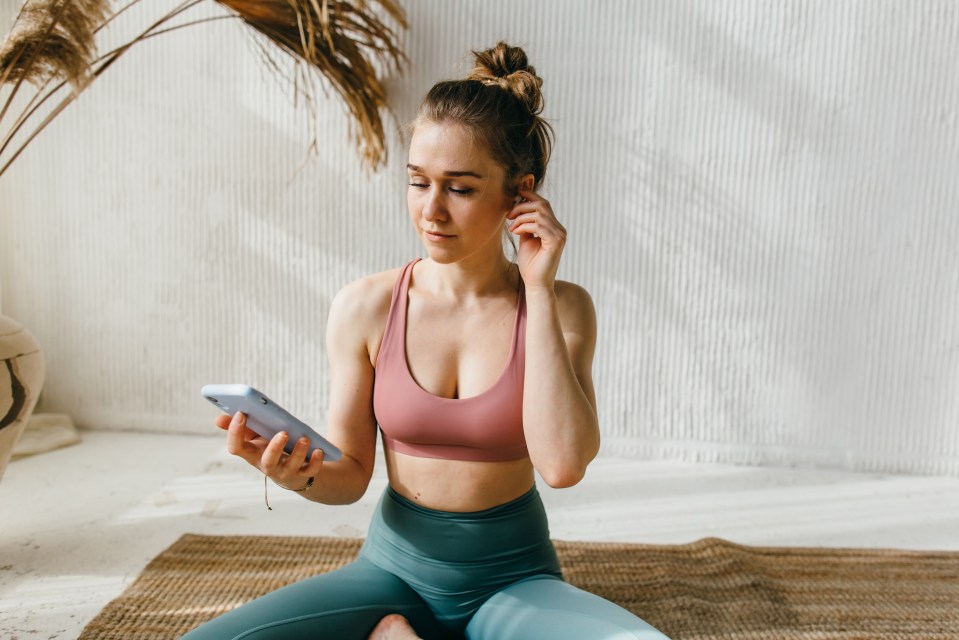 Woman in athletic wear using her smartphone.