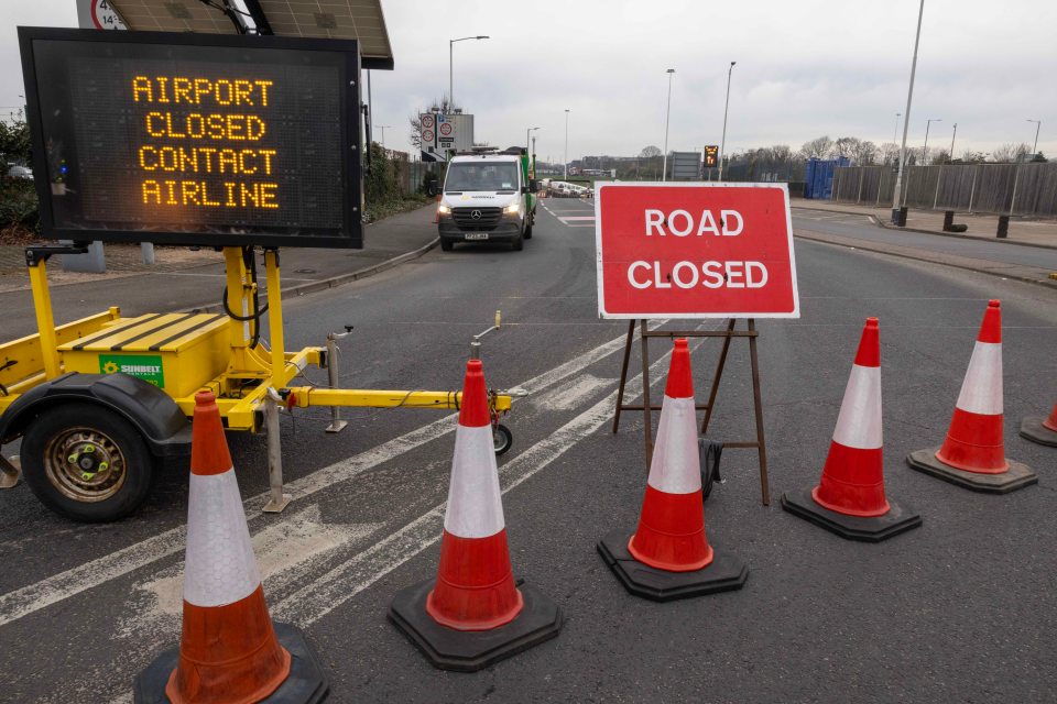 Heathrow Airport closed; road closed sign and traffic cones.