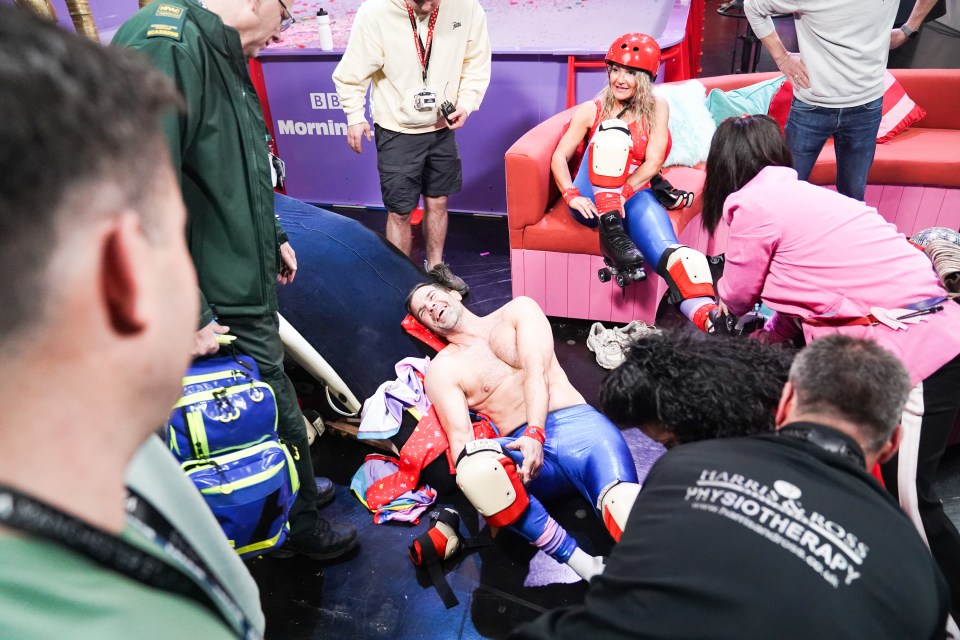 A man lies on the floor injured during a Red Nose Day fundraising roller skating challenge.