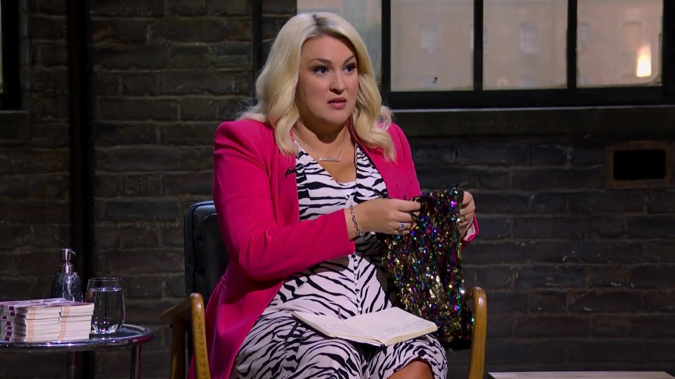 Sara Davies on Dragons' Den, holding a sequined item.