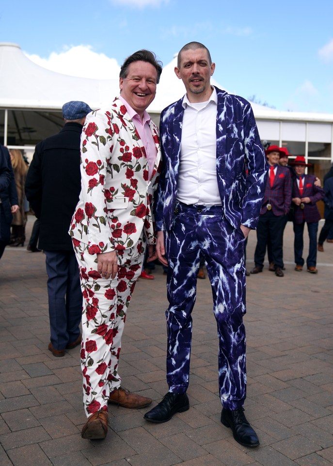 Two men in patterned suits at a racecourse.