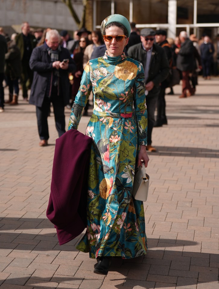 Woman in floral dress at a horse race.