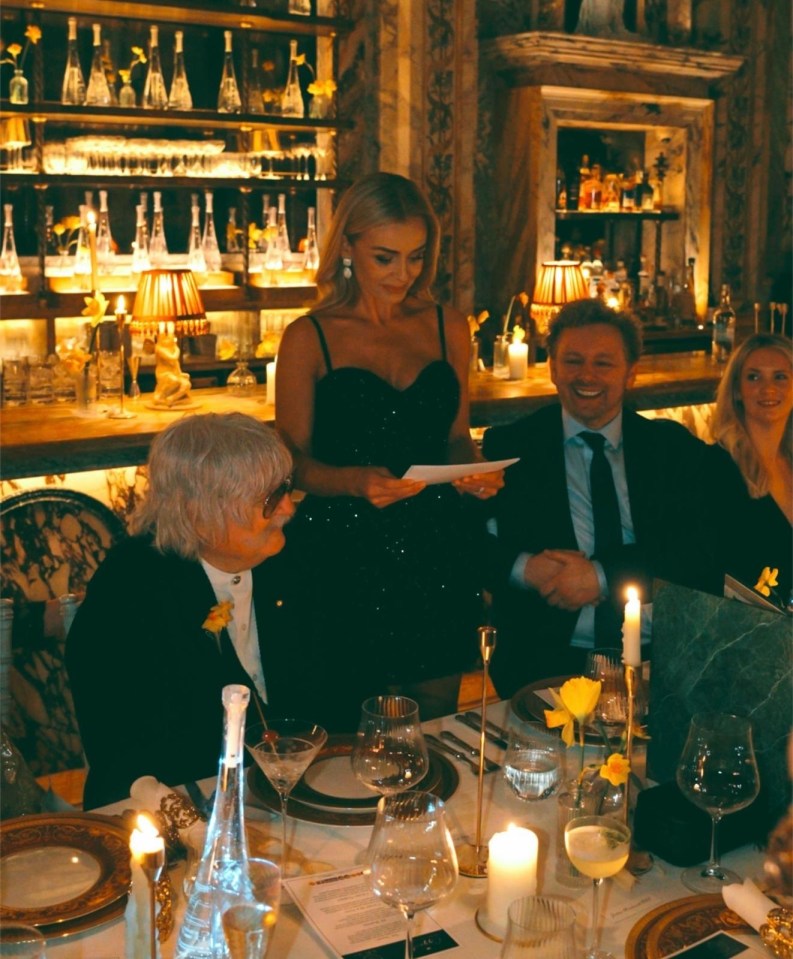 Woman reading at a formal dinner party.