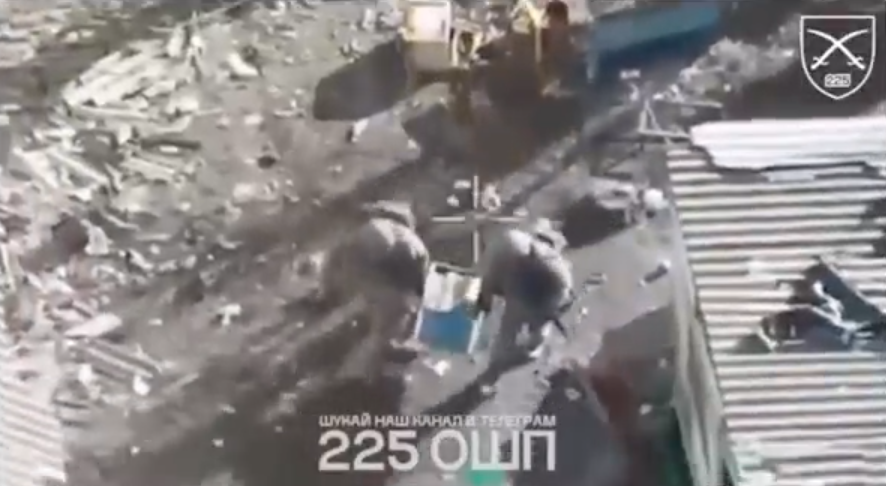 Screenshot of soldiers amidst rubble.