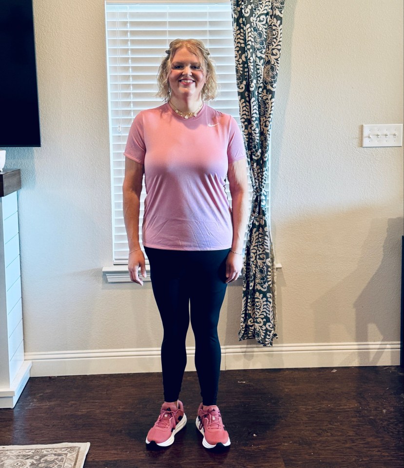 Woman in pink shirt and black leggings after weight loss.