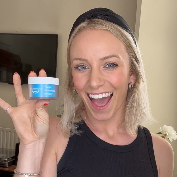 Woman holding teeth whitening powder.