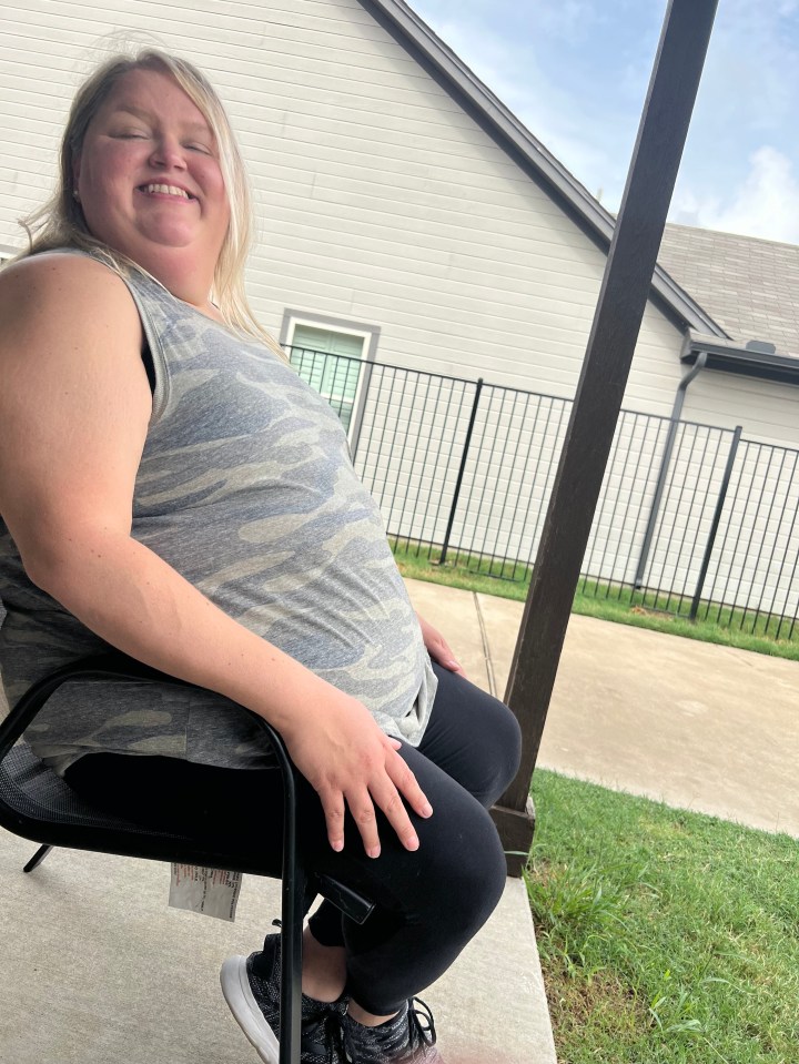Woman sitting outside before weight loss.