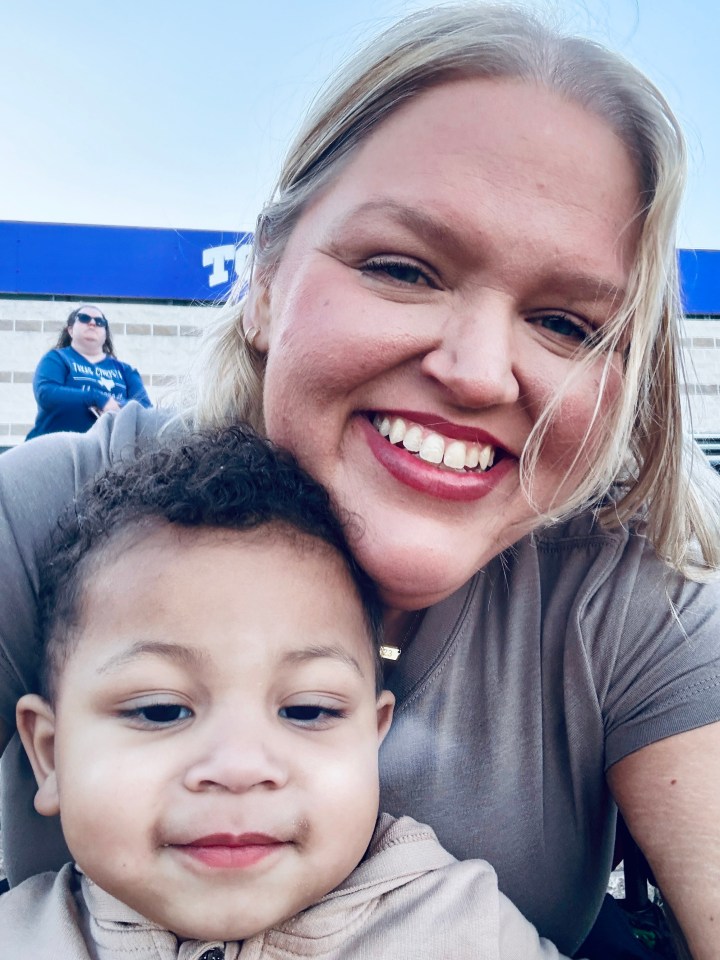 A mother and her young son smiling for a selfie.