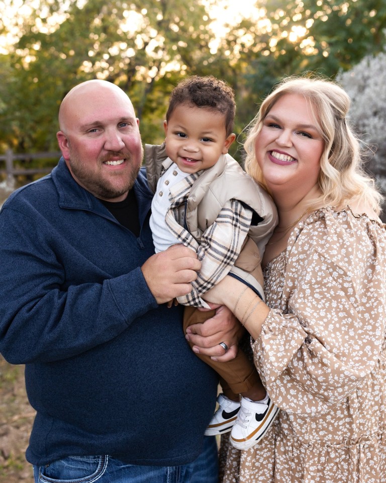 Family portrait of a mother, father, and their young son.